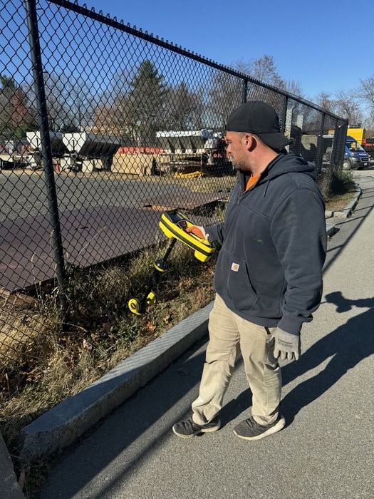 A technician carefully operating a state-of-the-art video pipe inspection system